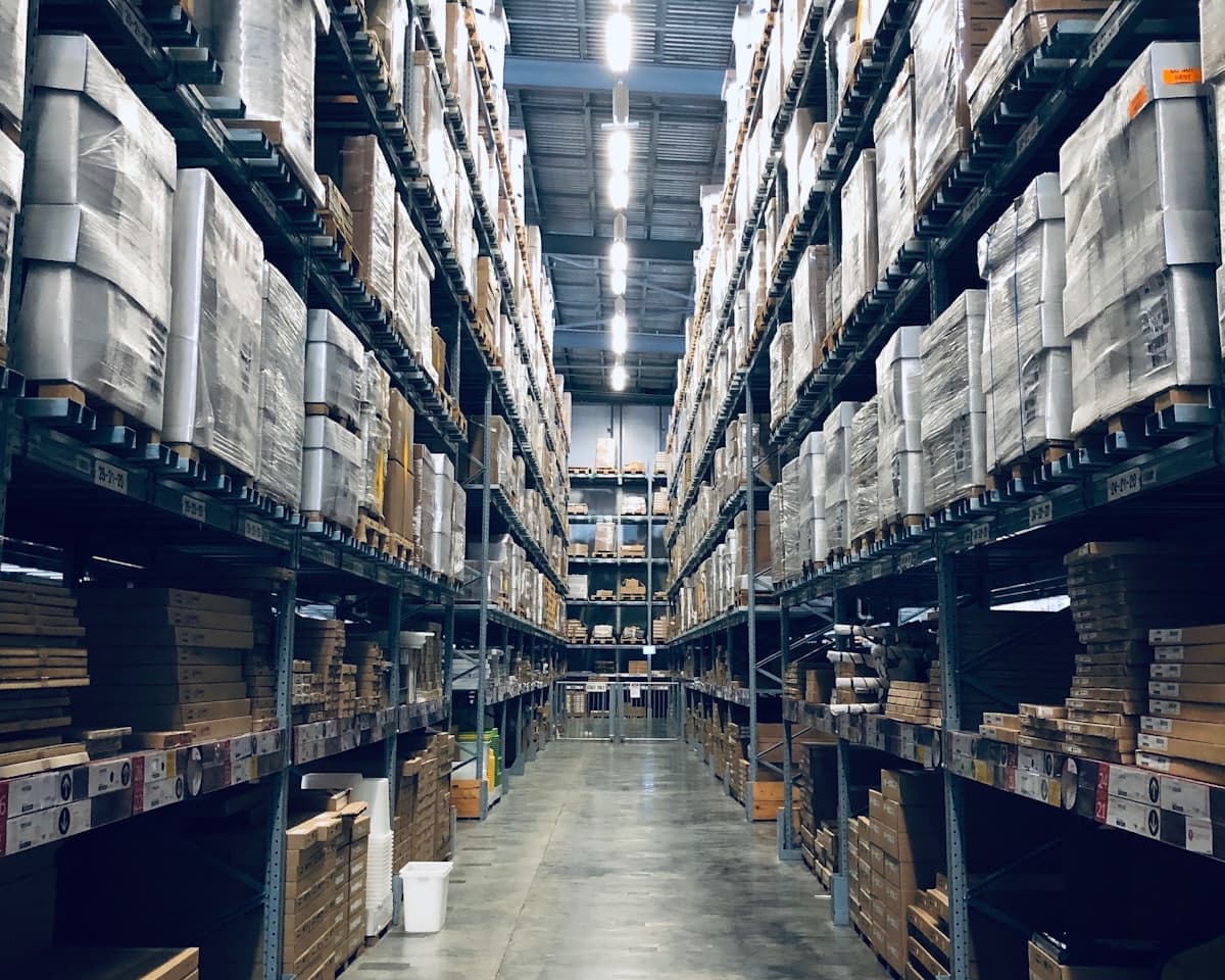 Long aisle of stacked pallet racking inside a warehouse